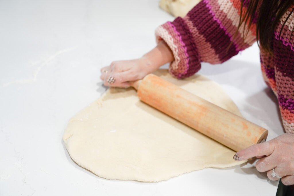 rolling the dough out to be 1/2 inch thick