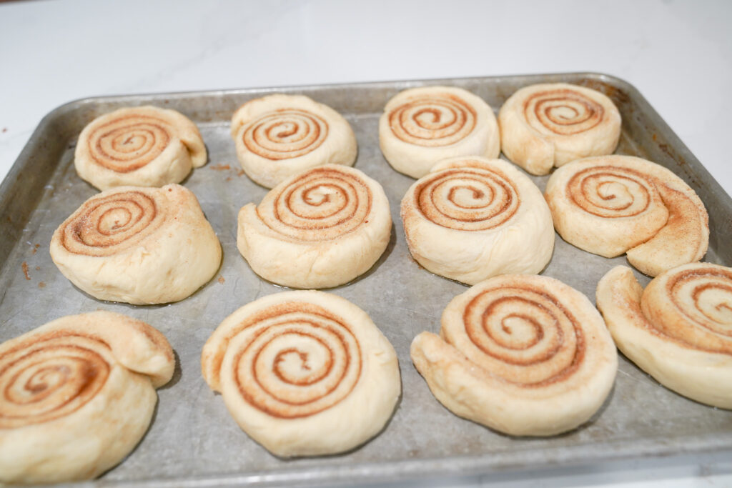 cinnamon rolls on a sheet pan before they go into the oven