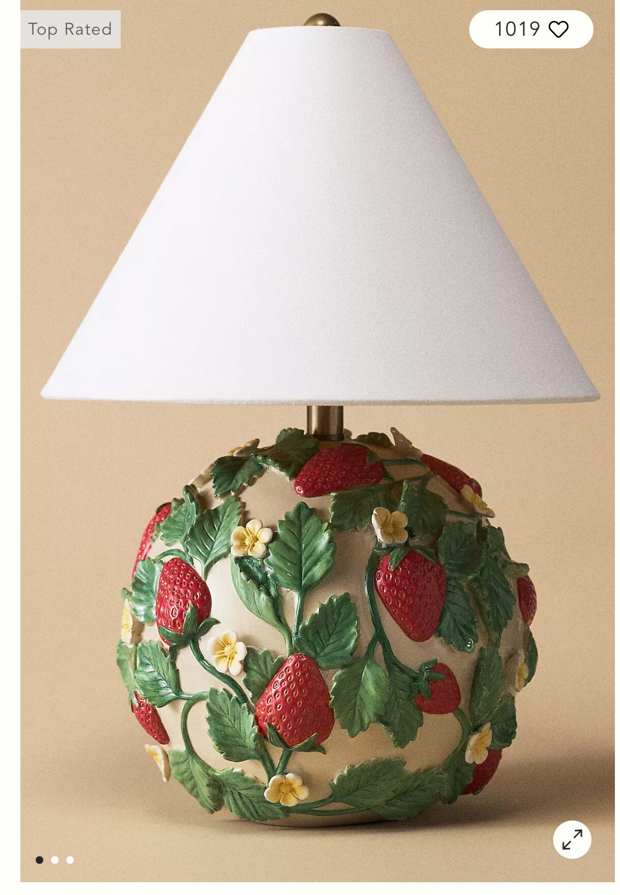 Official Anthropologie strawberry lamp featuring raised red strawberries, green vines, and yellow blossoms with a white linen shade.