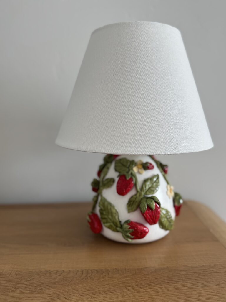 Completed DIY strawberry lamp with a white linen shade, inspired by the Anthropologie strawberry lamp design.
